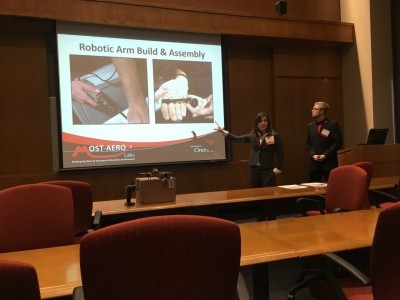 Man and woman in room presenting project powerpoint