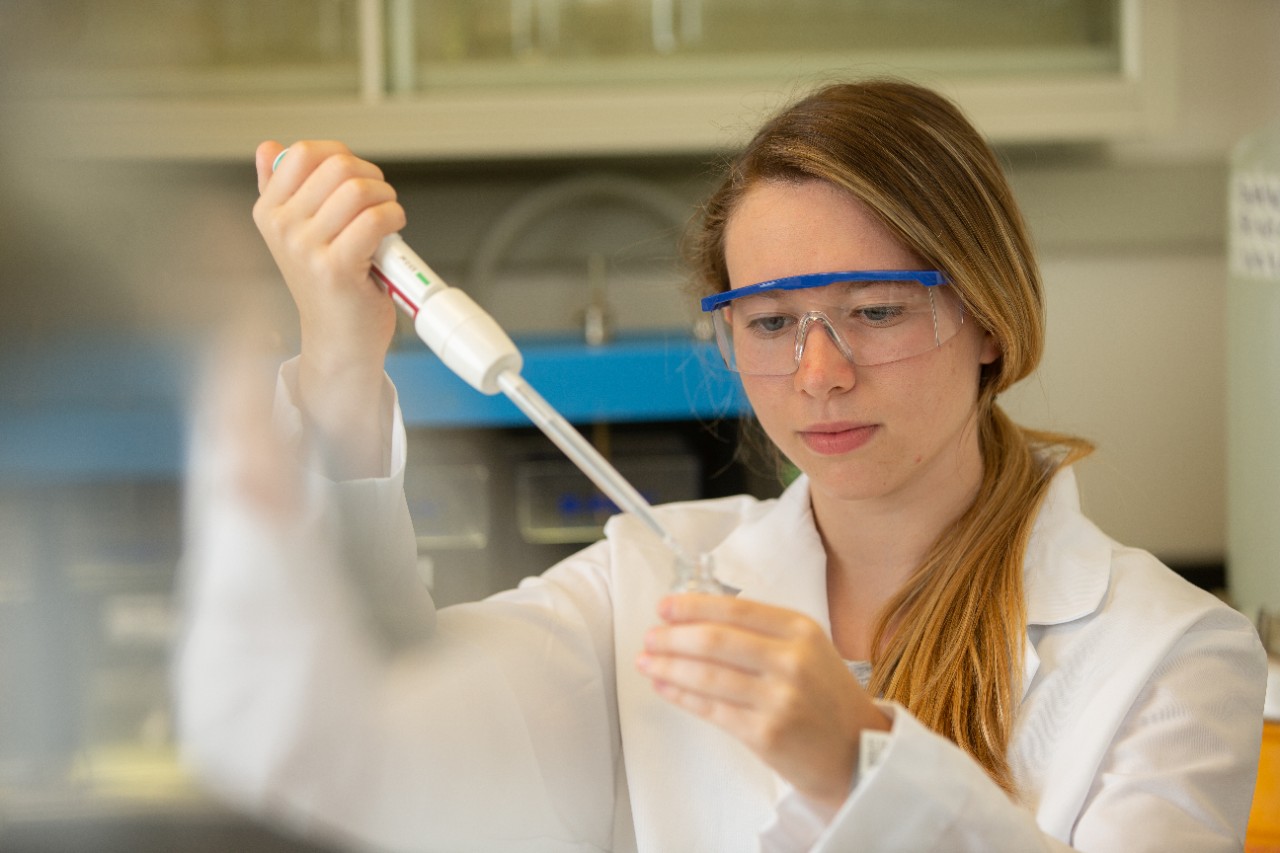 Students pose in an environmental engineering lab in Rhodes Hall.