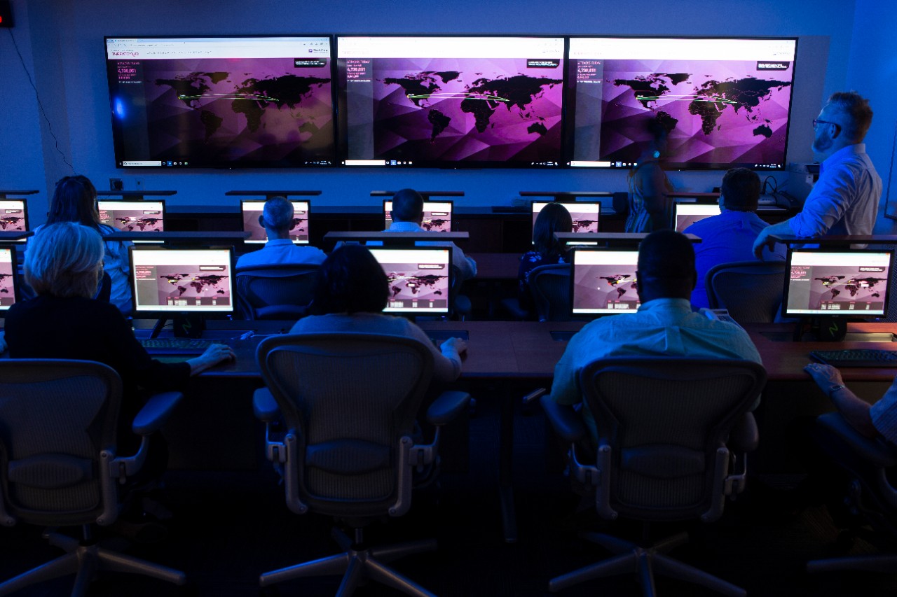 People at work in the Emergency Operations Center, stylized to illustrate cyber security for a UC Magazine feature on the Cyber Range.