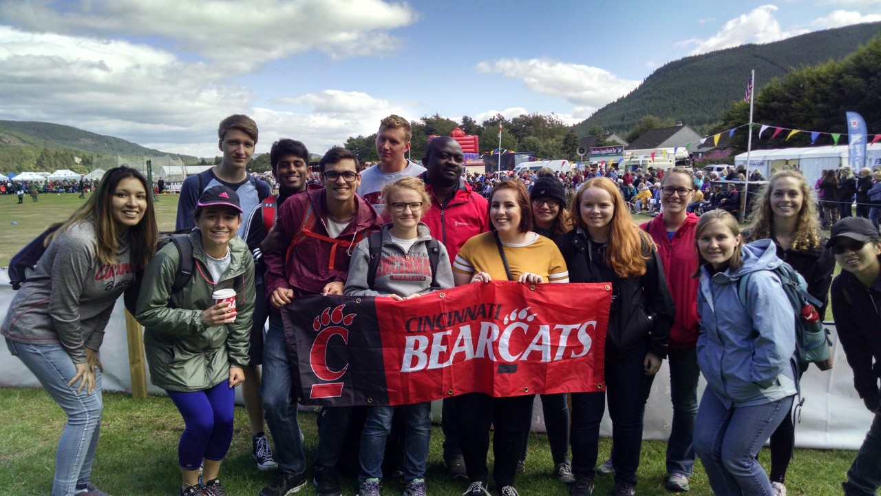 Group of students holding up Bearcats flag