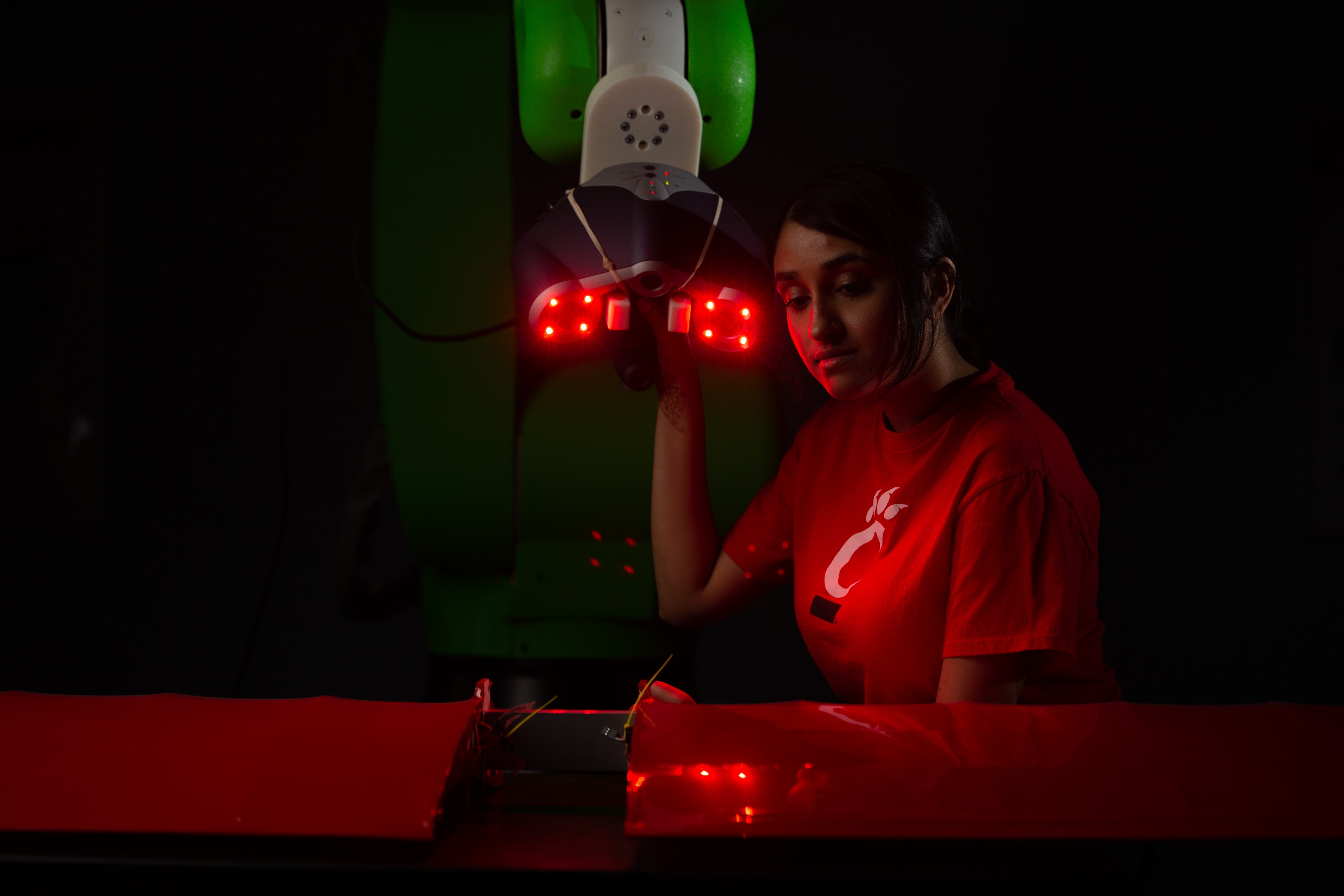 Students pose in Dr. Ou Ma's robotics lab in Rhodes Hall.