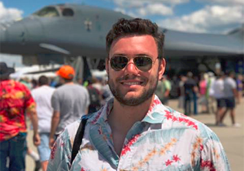 Zach Deutscher, aerospace engineering class of 2018, on co-op at GE aviation with airplanes in the background