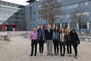 Seven UC students pose outside Technical University of Munich