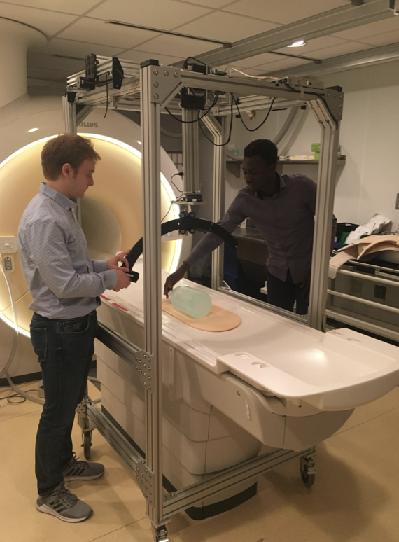 Two students setting up the MRI machine